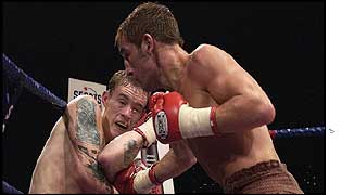 Steve Conway is on the receiving end of an Alex Arthur right hand