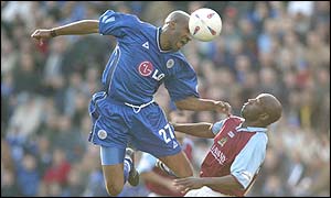 Brian Deane wins a header against Ian Cox 