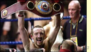Scott Harrison hoists his WBO featherweight belt