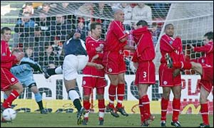 The Aberdeen defensive wall successfully keep out a Fabian Caballero free-kick