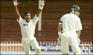 Pakistan quickie Waqar Younis claims the wicket of Damien Martyn