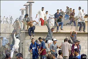 Relatives of Iraqi prisoners flee Iraqi guards after they forced 