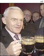 Polish Prime Minister Leszek Miller, whose country is one of the applicants, toasts with a pint of Guinness beer in a bar in Warsaw