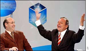 Alvaro Noboa (R) celebrates his second-place result live on TV