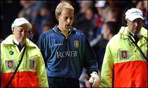 Aston Villa's goalkeeper Peter Enckelman is provided with an escort after his dismissal in the 1-0 defeat to Southampton