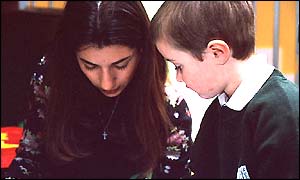 Teacher and school pupil look at work