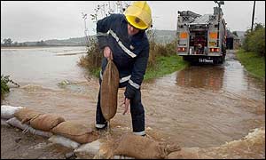 Firefighter laying sandbags