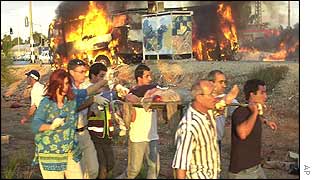 People carry an injured victim on a stretcher