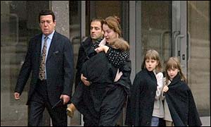 Russian singer Iosif Kobson (L) and his assistant escort a woman and her three daughters 