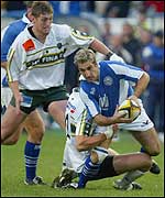 Bridgend's Matt James is tackled by a Pau defender