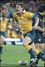 Mat Rogers, who has made an explosive start to his international career, celebrates scoring against New Zealand