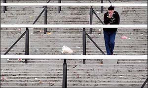 A lone fan stays on after Fulham's last match at Craven Cottage