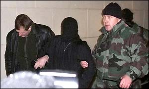 A rebel is led away by Moscow police