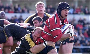 Gloucesters Junior Paramore (right) is tackled by Lawrence Dallaglio 