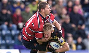 Stuart Abbott of Wasps is tackled by Henry Paul 