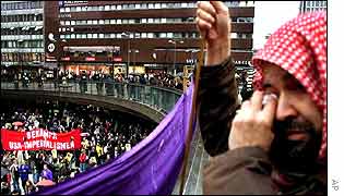 Man weeps as he holds an anti-war banner at a protest in Stockholm, Sweden
