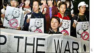 Anti-war protesters in Japan hold cartoons of Bush and a 