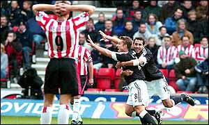 Lee Clark celebrates Fulham's opener as Southampton's James Beattie looks on in frustration
