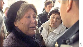 A woman shouts at a police officer who denies her entrance to a hospital 