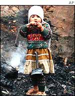 Girl amid ruins of her house in Kashmir