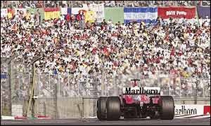 Michael Schumacher passes in front of the packed grandstands in Japan