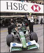 Eddie Irvine's Jaguar pulls out of the pits during qualifying for the Japanese Grand Prix