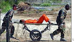 A detainee from Afghanistan is carried on a stretcher before being interrogated by military officials at Camp X-Ray 