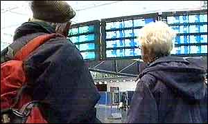 Passengers looking at departure boards