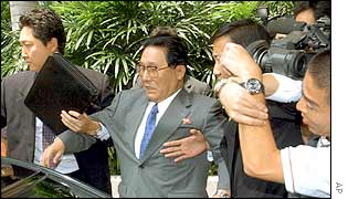 North Korean delegation chief Jong Thae-hwa (second from left) is escorted to his car after Wednesday's morning session