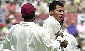 Mervyn Dillon (facing) is congratulated by a West Indian team-mate