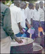 Students from Pader District queue up for food in a Lira camp 