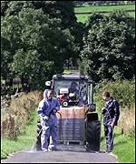 Workers disinfect a country road
