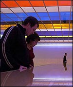 Visitors look at Liam Gillick's Coats of Asbestos Spangled with Mica