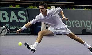 Tim Henman scrambles a forehand return