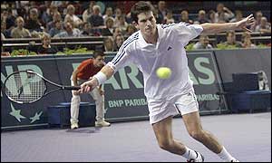 Britain's Tim Henman stretches for a forehand return