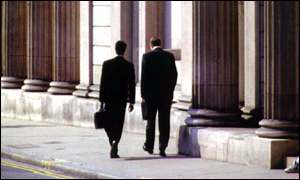 Two City workers walking down a street