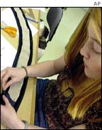 Seamstress Marie Sandoz works on a garment on her final day 