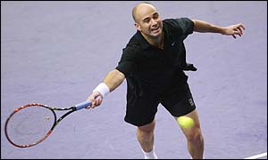 Andre Agassi stretches for a forehand return