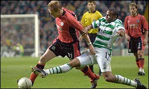 Blackburn winger Damien Duff evades the challenge of Celtic wing-back Didier Agathe