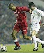 Hapoel Tel-Aviv's Carlos Silva Welton holds off Leeds defender Gary Kelly