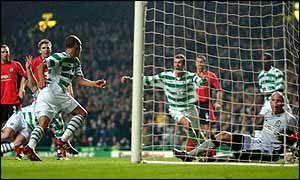 Celtic striker Henrik Larsson turns towards strike partner Chris Sutton after scoring against Blackburn