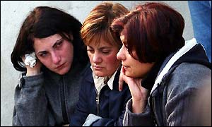 Three women weep after the earthquake 