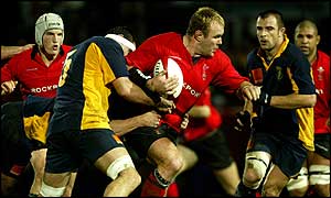 Scott Quinnell bursts past Romania's Christian Petre