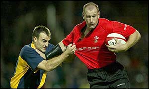 Welsh winger Gareth Thomas attempts to hand off a tackle from Romania's Gabriel Brezoianu
