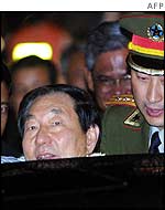 Chinese Prime Minister Zhu Rongji is escorted to his car in Phnom Penh