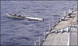 HMS Grafton nears the stricken boat