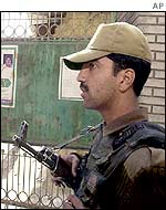 A police officer stands guard outside Mr Sayeed's house