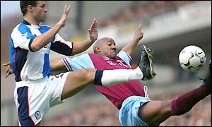 Lucas Neill contests a ball with Villa's Dion Dublin