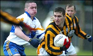 Crfossmaglen's John McEntee (right) breaks clear from Damian McDermott