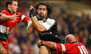 New Zealand's Henry Faa'fili is tackled by the Welsh defence